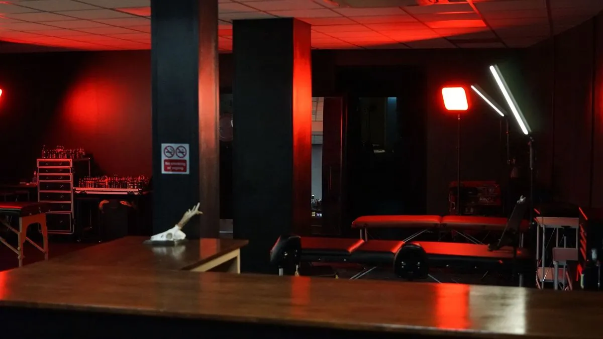 Close-up of tattoo equipment and ink pots laid out on a studio workstation